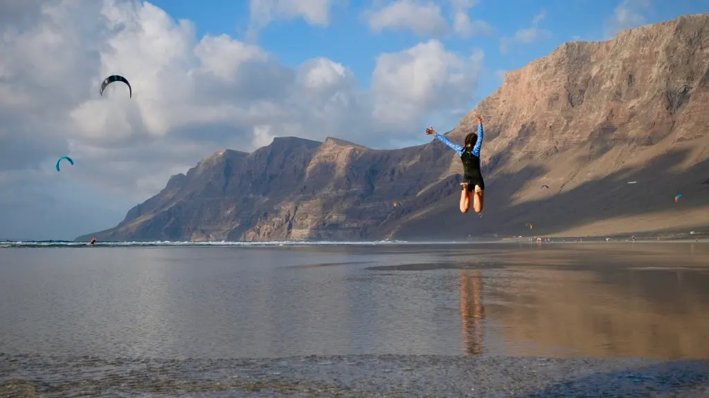 Famara beach at low tide with the cliffs mirrored in the sand